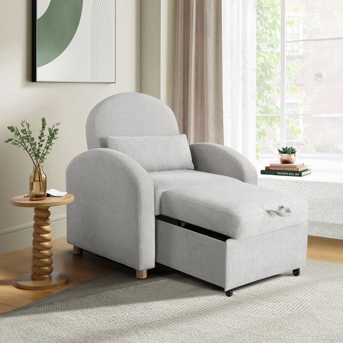 A modern lounge chair paired with a pull-out ottoman, complemented by a stylish side table holding a plant, and books placed on a window ledge in a cozy living room environment