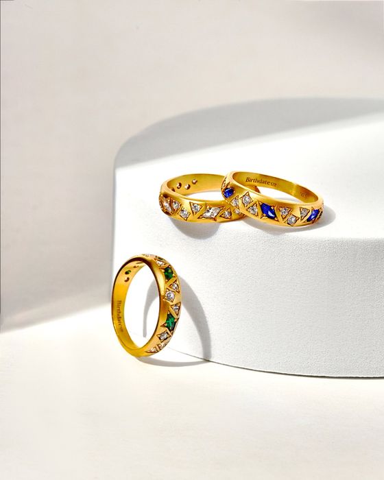 Three elegant rings with marquis-cut stones in various vibrant colors.
