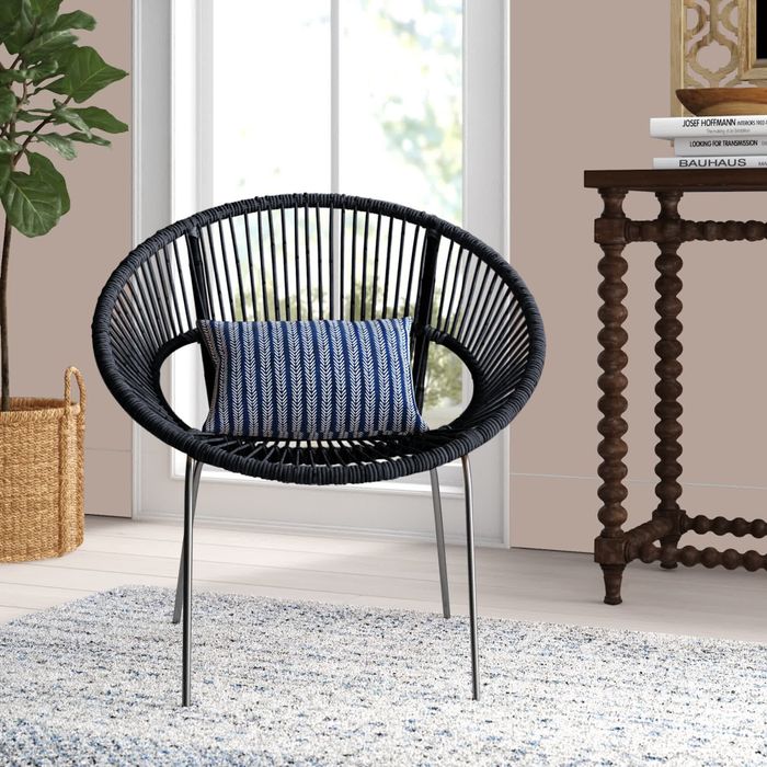 An image of a sleek black chair with a bright blue cushion.