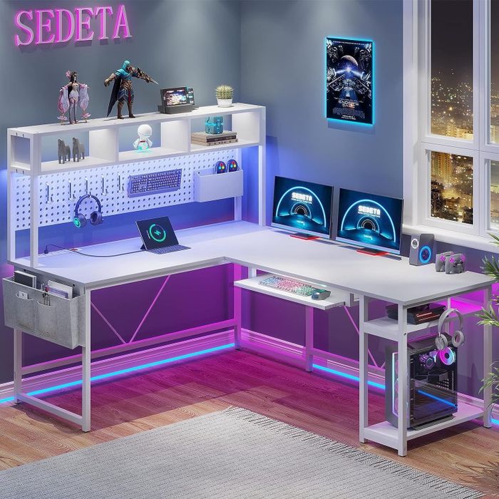 The white desk illuminated by pink and blue LED lights
