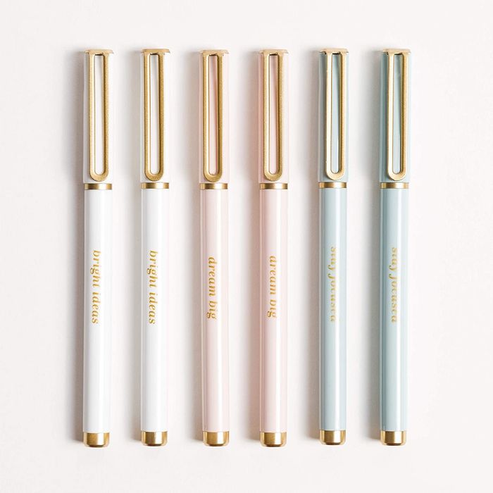 A set of pens in white, pink, and light blue.