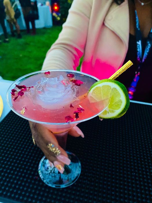 A rose-shaped ice cube in a cocktail.