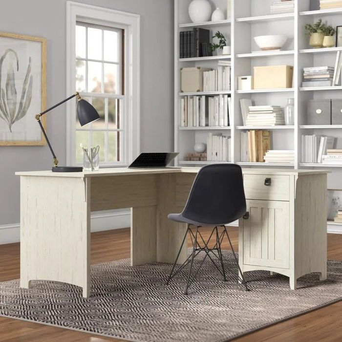 a white wooden L-shaped desk