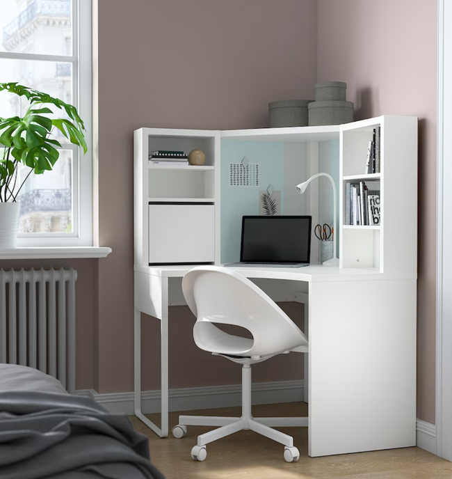 the white corner desk with a hutch and several cubby spaces