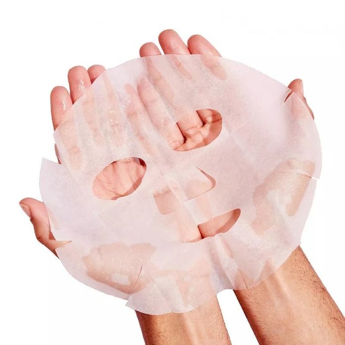 Hands holding the sheet mask