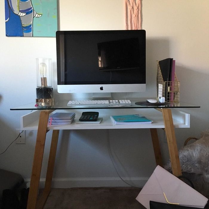 A reviewer’s photo of their office setup featuring the glass-top desk