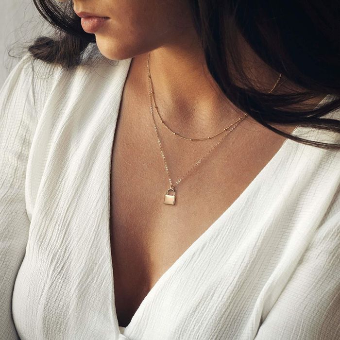 A model showcasing the layered lock necklace
