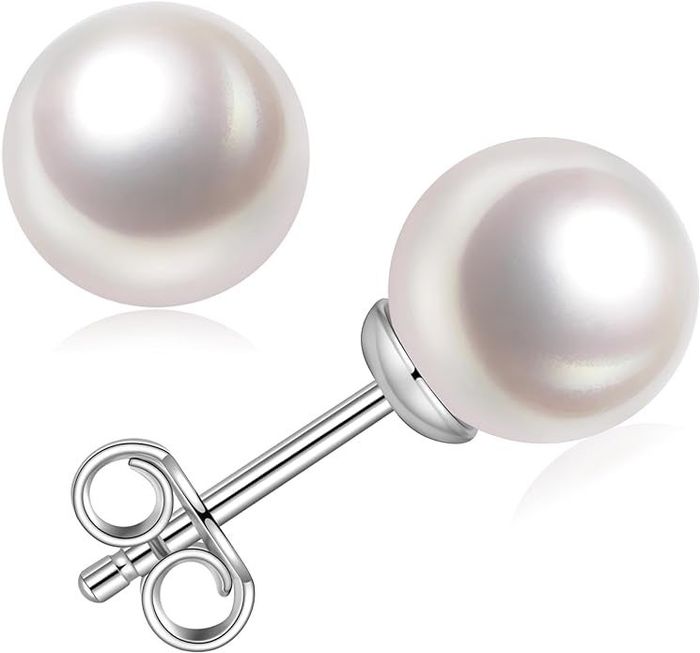 Close-up view of a pair of pearl stud earrings with silver posts