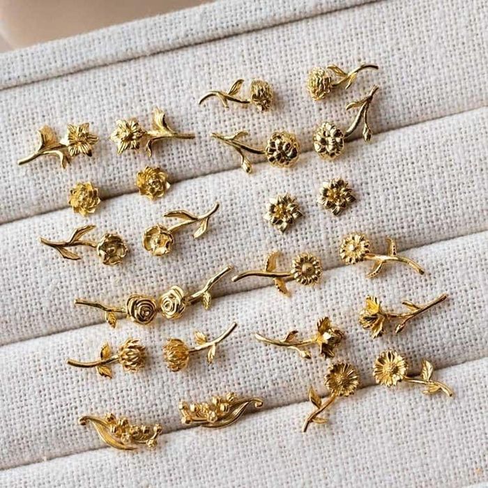Gold earrings with birth flower designs