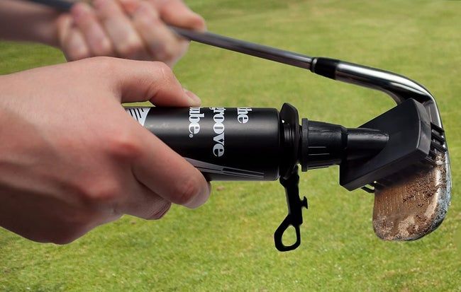 A squeeze bottle with an attached brush, perfect for cleaning golf clubs