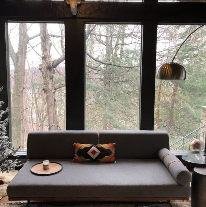 A dark grey, flat futon-style couch