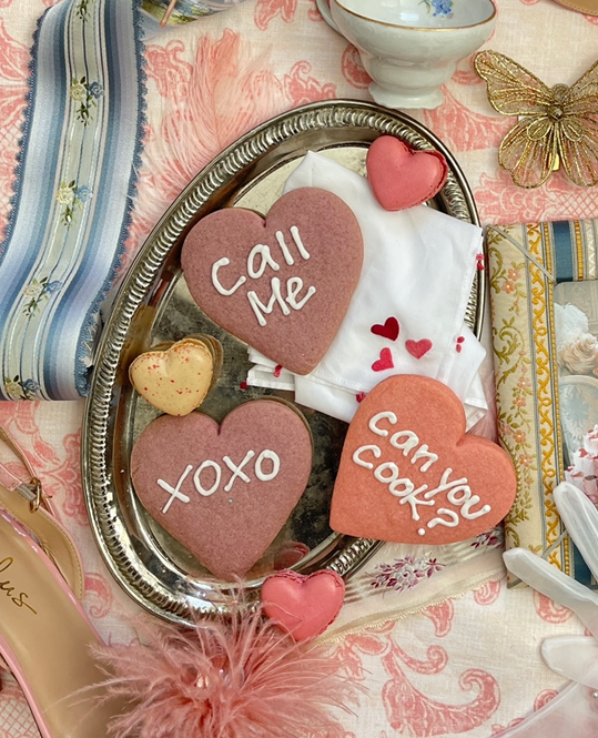 Heart-shaped cookies decorated with playful sayings.