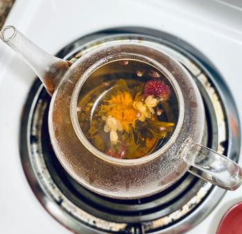 Close-up of a blooming tea infuser on the stovetop