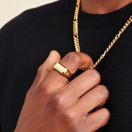 A male model showcasing a gold signet ring