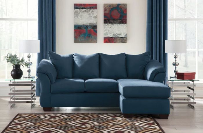 A long, navy blue L-shaped sectional sofa