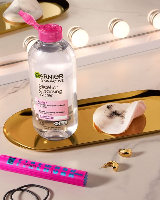 A bottle of micellar water accompanied by a cotton pad