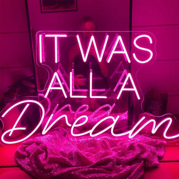 a neon LED sign glowing in pink that says