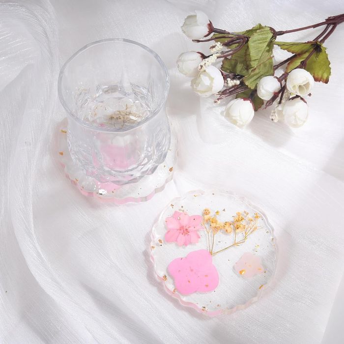 Pressed pink flowers encased in acrylic coasters.