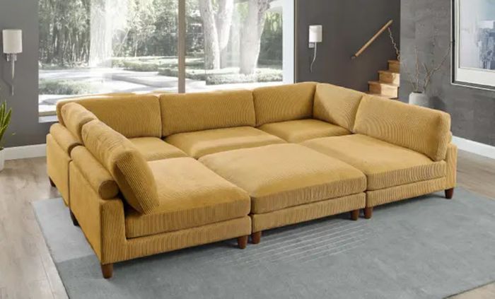 a giant yellow couch that doubles as a massive bed, comfortably accommodating the entire family, complete with soft cushions