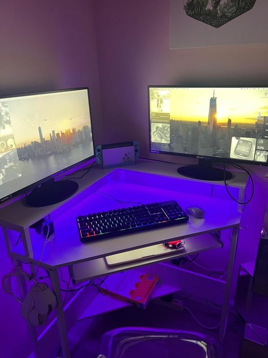 a reviewer's workspace with purple lighting and dual monitors