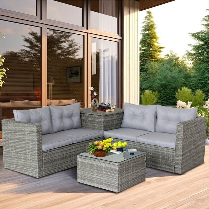 A gray outdoor patio set featuring a sectional, a storage ottoman, and an additional storage side table.