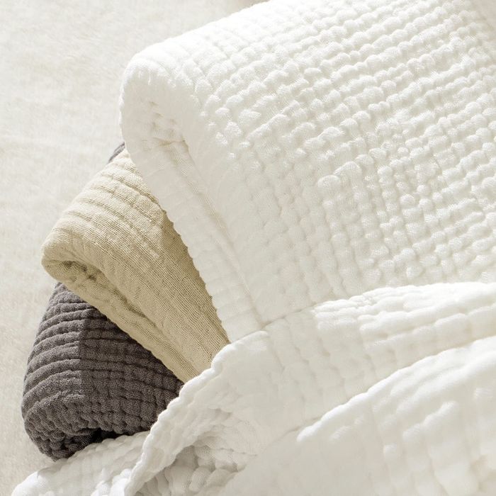 Close-up of the corners of three blankets to showcase the texture