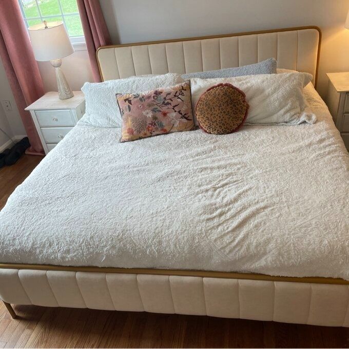 A reviewer’s image of the gold and white bed