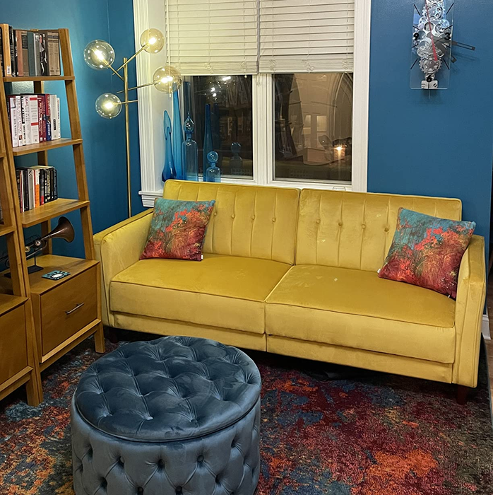 reviewer's vibrant yellow velvet futon