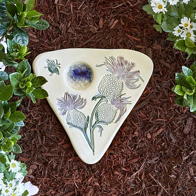 A triangular puddler in the garden designed with thistle detail
