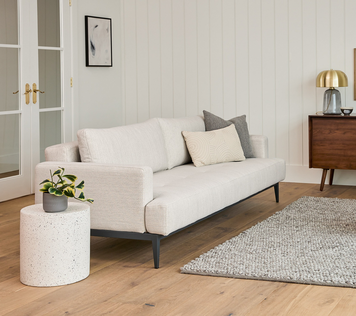 the cream-colored sofa in its upright position