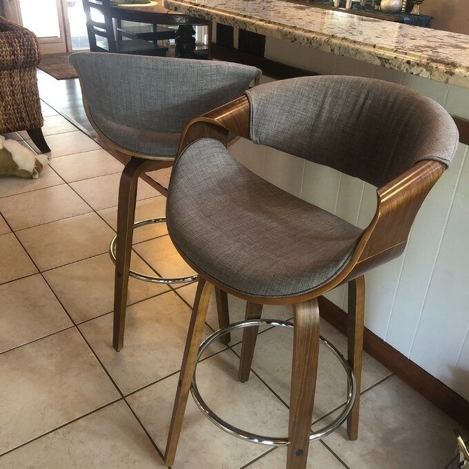 A stylish bar stool featuring plush gray cushions, perfect for modern kitchens.