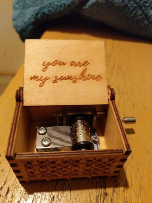 The music box opened, with the inscription 