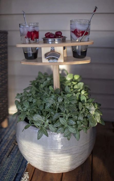 The same table with the stake inserted into a large potted plant.