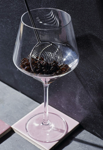 Close-up of a boozy boba served in a wine glass