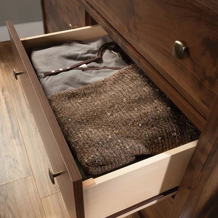 An open drawer filled with sweaters
