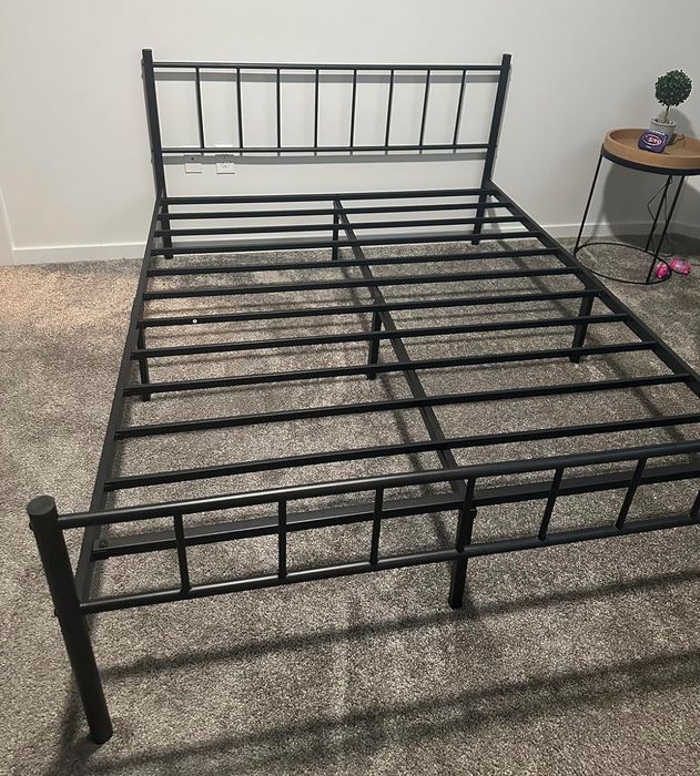 A black metal bed frame showcased in a minimalist room, perfect for contemporary home decor.
