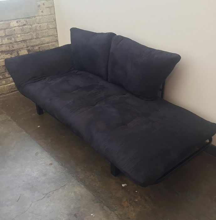 reviewer's black futon with one side reclined