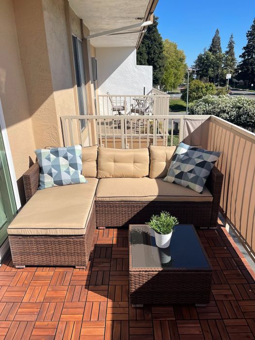 A reviewer's photo of a beige three-piece sectional neatly arranged on a balcony.