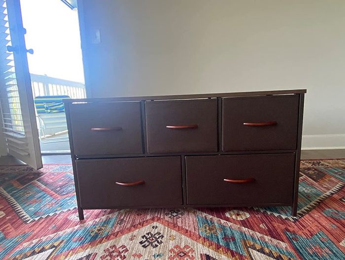 A brown 5-drawer dresser.