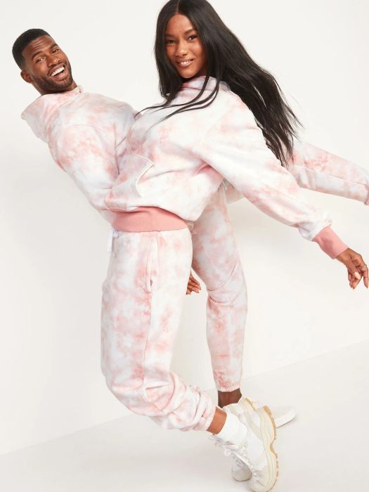 Models showcasing matching pink tie-dye sweatshirts and pants