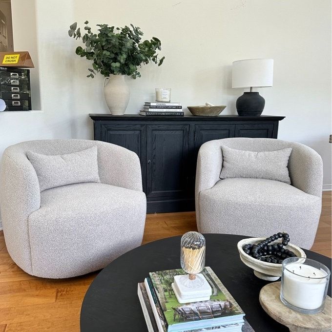 A pair of elegant taupe-colored swivel chairs, beautifully styled in a reviewer’s living space.