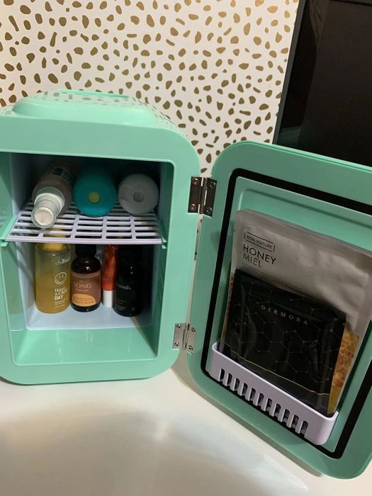 A photo shared by a reviewer of their mint green mini fridge