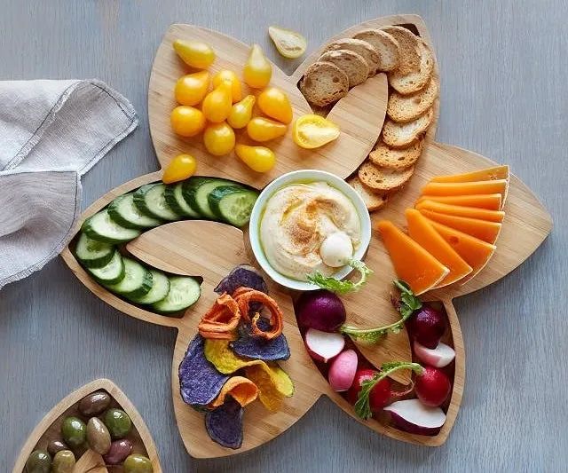 The tray with an assortment of hors d'oeuvres arranged on top