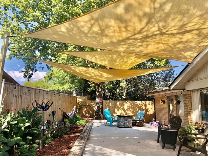 Three triangular shades set up in another reviewer’s backyard, offering ample shade and style.