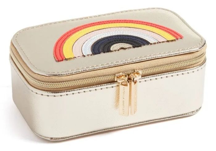 A gold rectangular zippered jewelry box featuring a rainbow stitched on its surface.