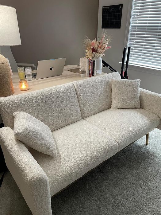 the white teddy fabric sleeper sofa in the reviewer's office