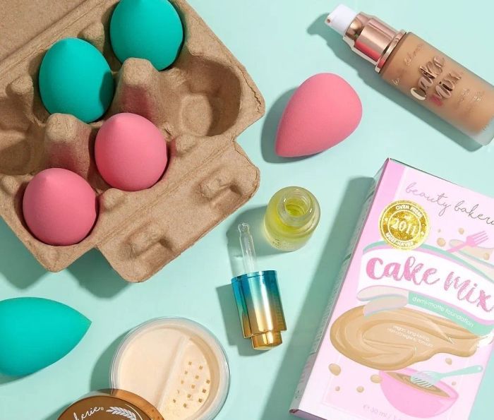 The opened cart filled with egg blenders alongside other makeup essentials.