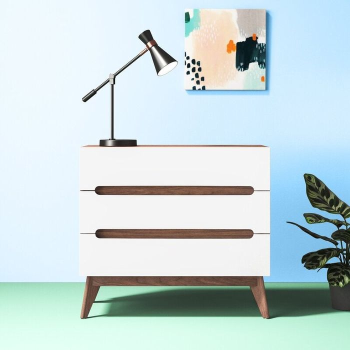 Styled shot of a sleek white dresser in a cozy setting