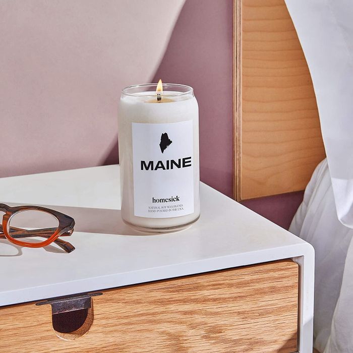 A Maine candle placed on a bedside table