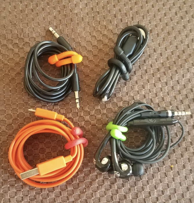 four charging cables neatly organized with rubber twist ties